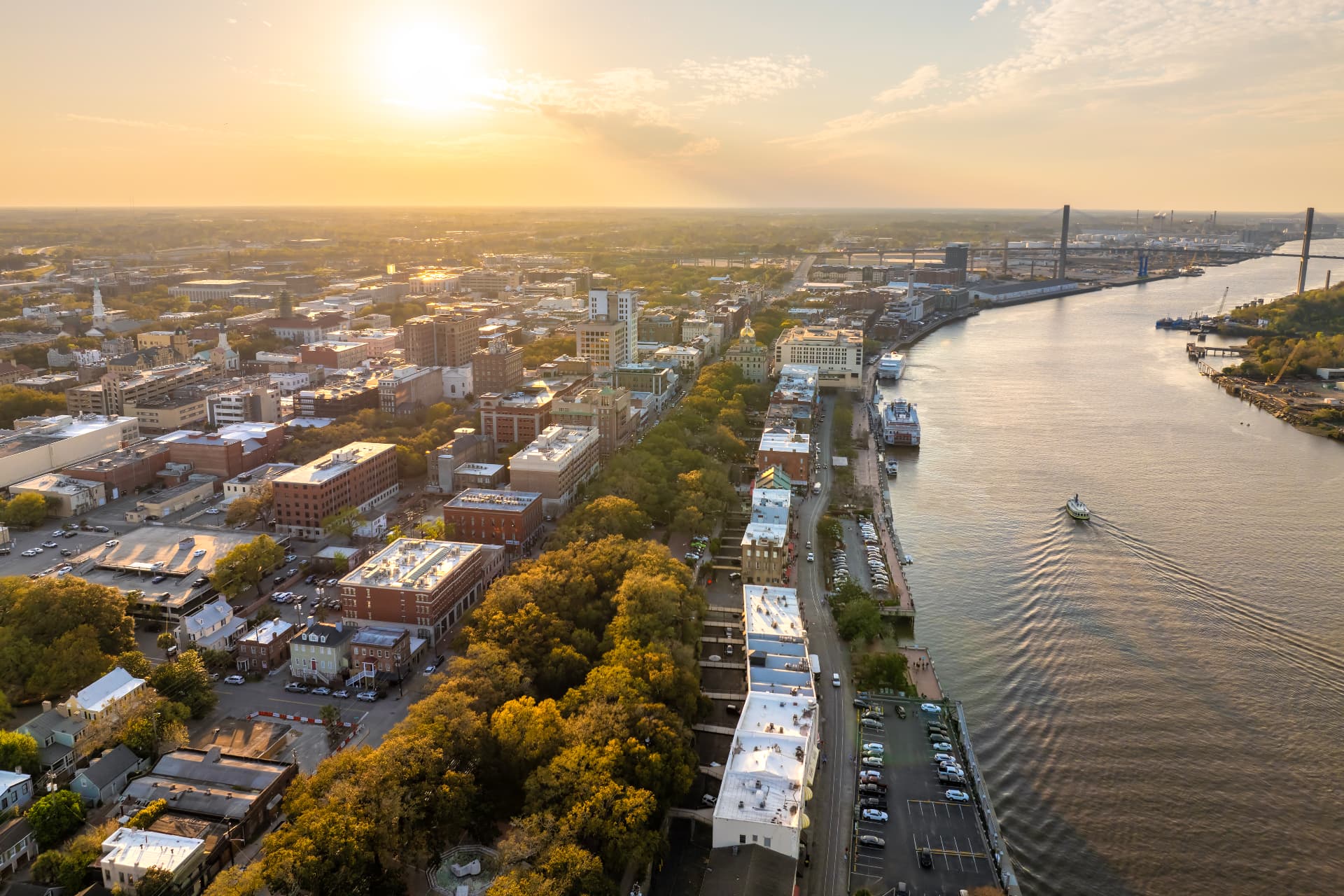 Aerial view of Savannah's historic riverfront and the Savannah River at sunset